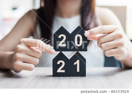 Young Businesswoman hands holding key and wooden 66153924