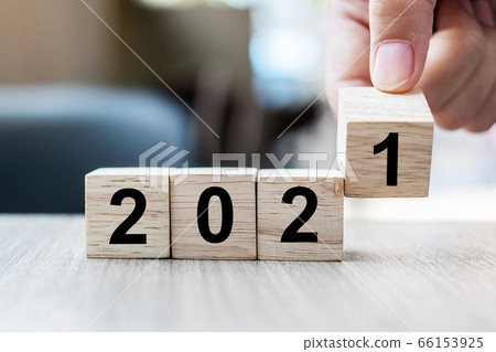 Businessman hand holding wooden cube with block 66153925