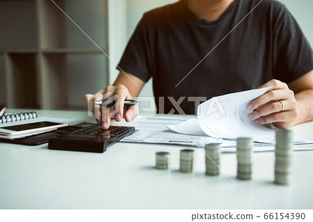 Asian men are calculating about finances about the Asian men are calculating about finances about the 66154390