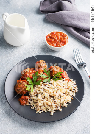 Beef meatballs and brown rice on a plate. Ready made portioned dish meat with garnish. Copy space. Beef meatballs and brown rice on a plate. Ready made portioned dish meat with garnish. Copy space. 66154643