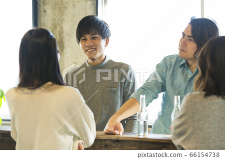 Men and women group chatting at the bar counter Men and women group chatting at the bar counter 66154738