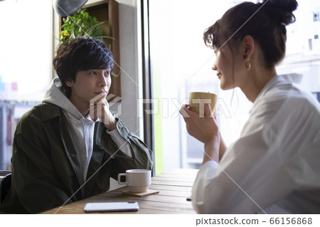 Men and women relaxing in a cafe Men and women relaxing in a cafe 66156868