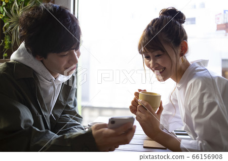 Men and women relaxing in a cafe Men and women relaxing in a cafe 66156908
