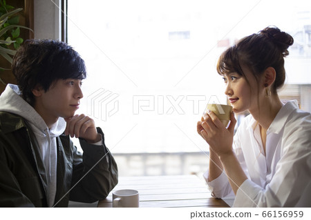 Men and women relaxing in a cafe Men and women relaxing in a cafe 66156959