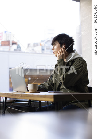 A man looking at a personal computer 66156960