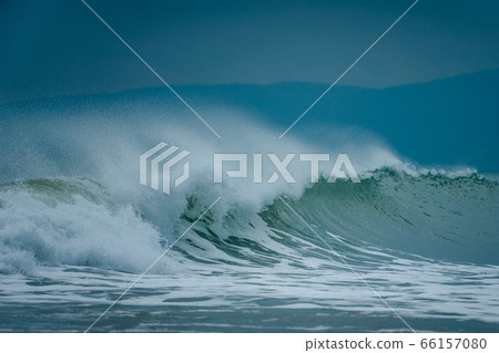 Sea swell wave with spray on top coming to beach Sea swell wave with spray on top coming to beach 66157080