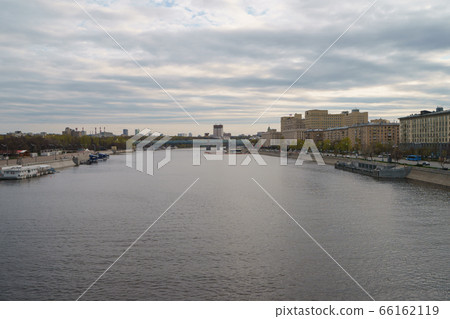 Moscow cityscape in in day. Wide Moskva River. Closed public Groky Park on left, Frunzenskaya embankment on right. Academy of Sciences, Andreevsky /Pushkinsky pedestrian bridge, Ministry of Defence 66162119