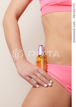 Woman applying moisturizing body oil lotion Woman applying moisturizing body oil lotion 66162270