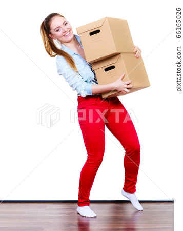 Happy woman moving into house carrying boxes. Happy woman moving into house carrying boxes. 66165026