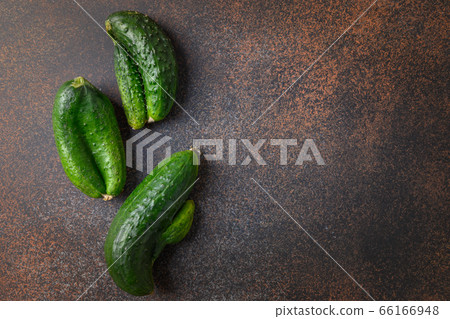 Ugly three cucumbers. Concept organic vegetables. 66166948