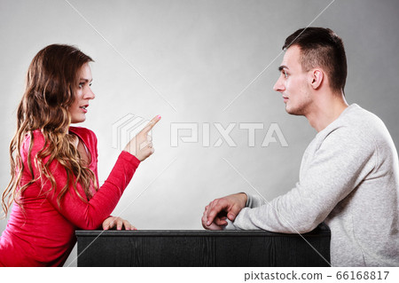 Woman warning man. Girl threatening with finger. Woman warning man. Girl threatening with finger. 66168817
