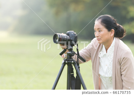 Senior woman's hobby camera 66170735