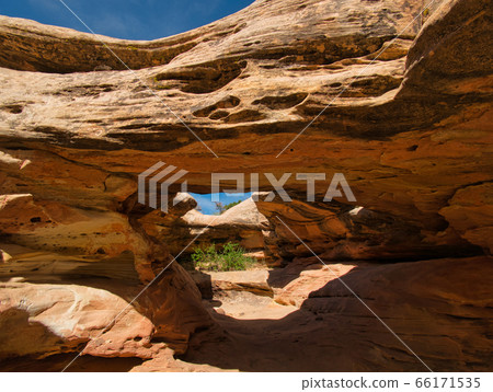 A bizarre rock formation with tunnel and cave A bizarre rock formation with tunnel and cave 66171535