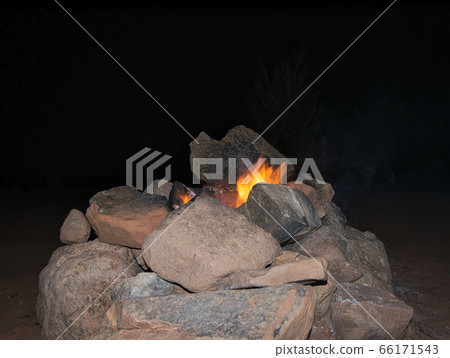 Small campfire in stone fireplace 66171543