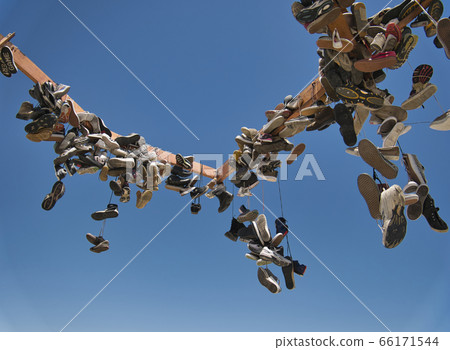 Numerous shoes hang on a steel frame Numerous shoes hang on a steel frame 66171544