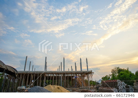 Perspective of house structure under construction at site with blue sky background Perspective of house structure under construction at site with blue sky background 66172946