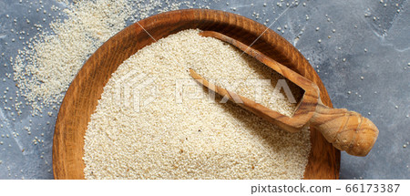 Raw uncooked fonio seeds with a spoon grey 66173387