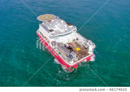 Large Platform supply ship with Helipad and two large cranes, anchored at Sea. Large Platform supply ship with Helipad and two large cranes, anchored at Sea. 66174620