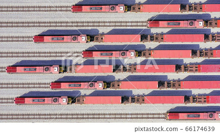 Freight Trains hauling a long load of Shipping Containers. 66174639
