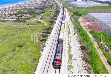 Freight Train hauling a long load of Shipping Containers. Freight Train hauling a long load of Shipping Containers. 66174679