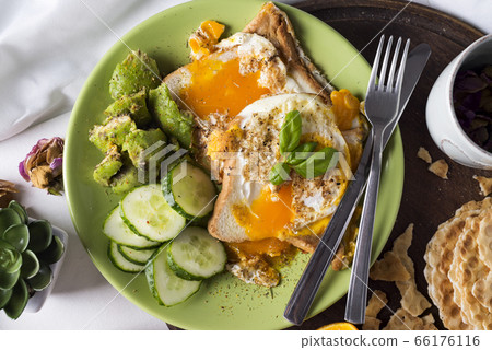 Fried eggs with toasts and tea in bed 66176116