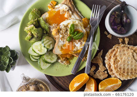 Fried eggs with toasts and tea in bed 66176120