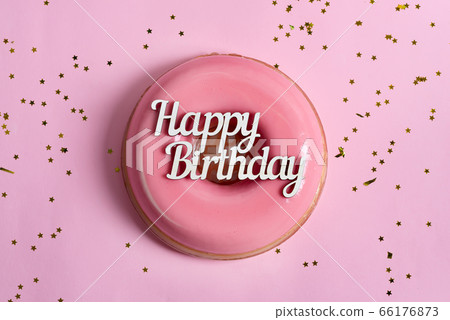 Text Happy Birthday above freshly cooked homemade fruit glazed dessert on a pink background with decoration. Text Happy Birthday above freshly cooked homemade fruit glazed dessert on a pink background with decoration. 66176873