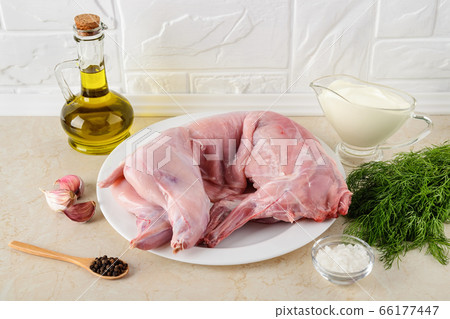 Whole raw rabbit carcass, sour cream, garlic, pepper, salt, olive oil and bunch of dill. Whole raw rabbit carcass, sour cream, garlic, pepper, salt, olive oil and bunch of dill. 66177447