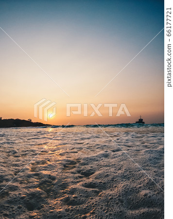 Silhouette fisherman boat and bubble wave with the sunset scene for background concept 66177721