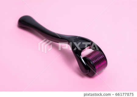 Derma roller on a pink background.  66177875