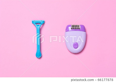 Purple epilator and blue razor on a pink Purple epilator and blue razor on a pink 66177878