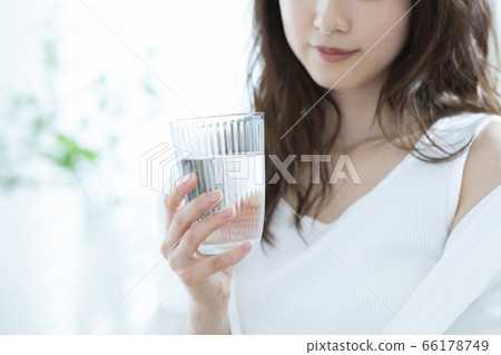 Woman drinking water in the morning 66178749
