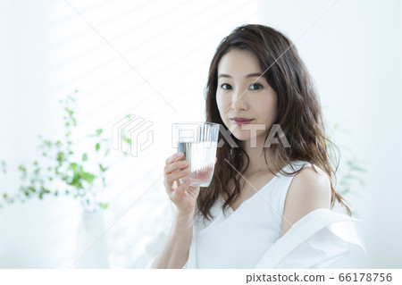Woman drinking water in the morning 66178756