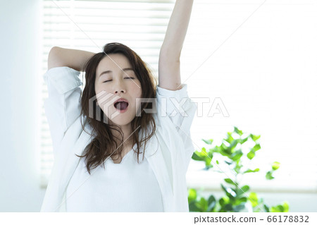Woman waking up in the morning Woman waking up in the morning 66178832