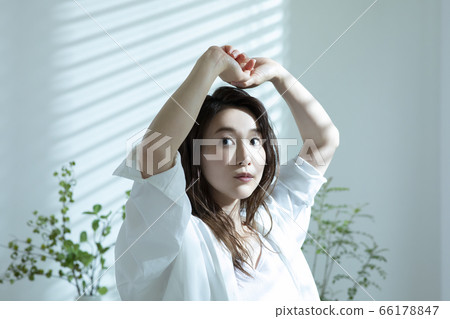 Woman waking up in the morning Woman waking up in the morning 66178847