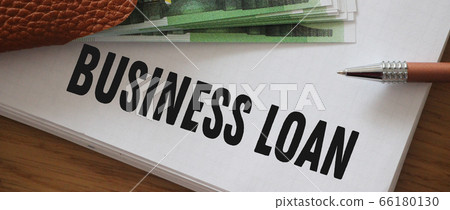 Business loan words on copybooks page and some 100 Euros billslaying on page. Business stratup credit concept Business loan words on copybooks page and some 100 Euros billslaying on page. Business stratup credit concept 66180130