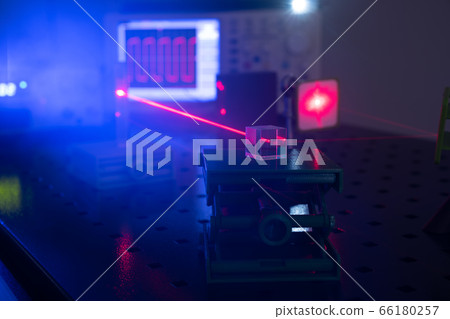 Experiment in optic lab with laser device. Red Experiment in optic lab with laser device. Red 66180257