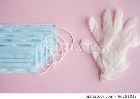 Medical protective mask and rubber gloves lie on a blue background. Anti-virus protection kit against covid-19. Coronavirus pandemic 2019. 66181832