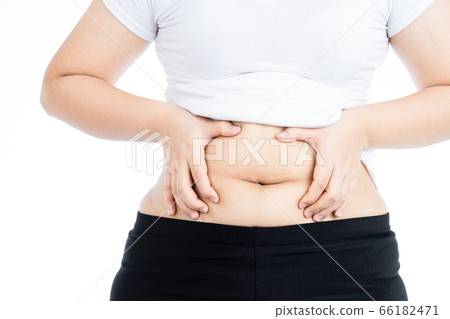 Fat woman holding excessive fat belly, overweight Fat woman holding excessive fat belly, overweight 66182471