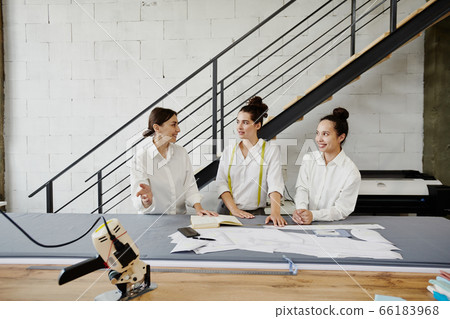 Young fashion designers in white shirts brainstorming and discussing ideas 66183968