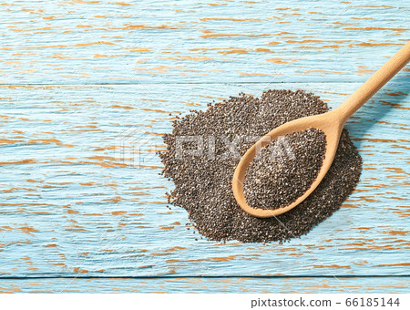 raw seeds of chia seeds in a wooden spoon on a raw seeds of chia seeds in a wooden spoon on a 66185144
