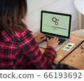 Woman settings electronic on her device. Network 66193692