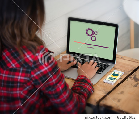 Woman settings electronic on her device. Network Woman settings electronic on her device. Network 66193692