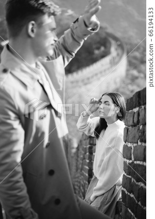 beautiful young couple posing at the Great Wall of China 66194133