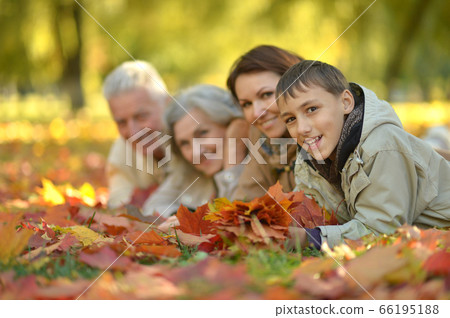 Portrait of happy family relaxing in autumn forest Portrait of happy family relaxing in autumn forest 66195188