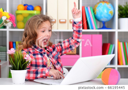 Portrait of emotional cute girl using laptop Portrait of emotional cute girl using laptop 66195445