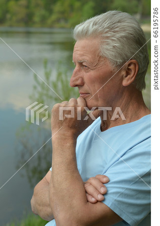 Portrait of senior man thinking in park 66195786
