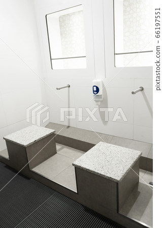 Stylish touchless washstand in a public toilet. Stylish touchless washstand in a public toilet. 66197551