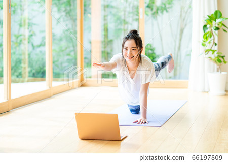 Woman doing yoga online 66197809
