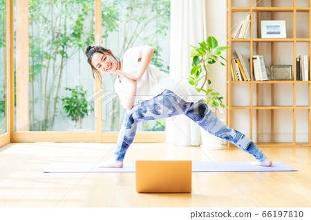 Woman doing yoga online 66197810
